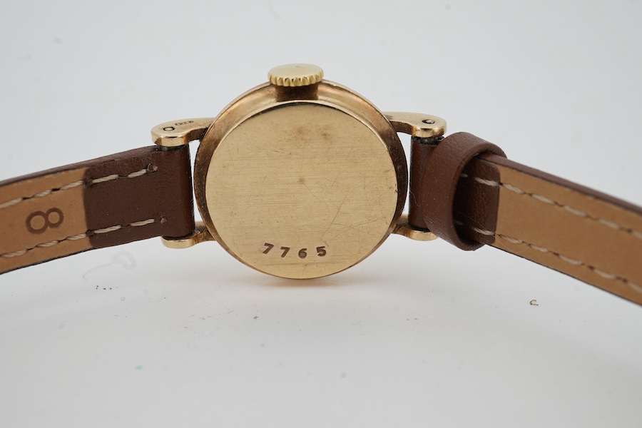 A lady's 9ct gold Jaeger LeCoultre manual wind wrist watch, with baton and quarterly Arabic numerals, cased diameter 20mm, on an associated leather strap, no box or papers.